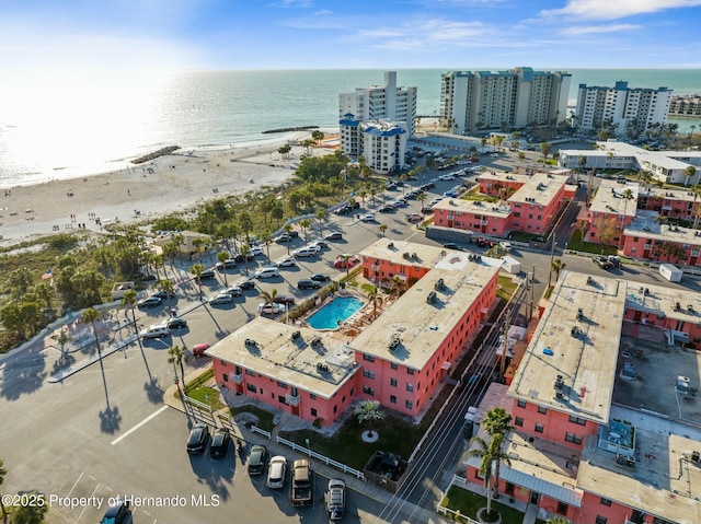 bird's eye view with a water view, a view of the beach, and a city view