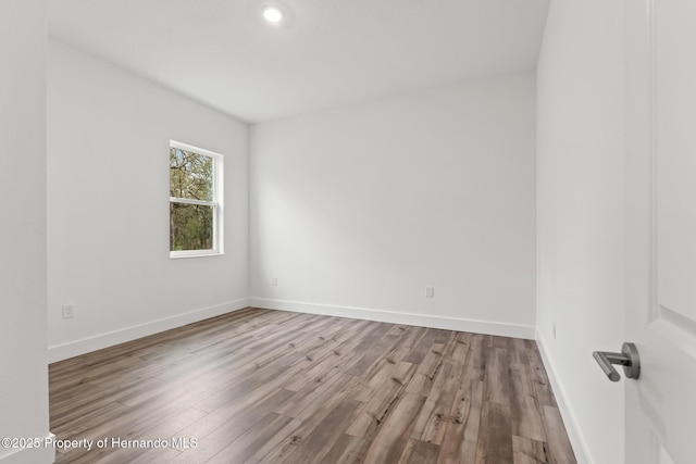 empty room with wood finished floors and baseboards