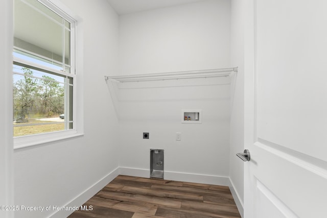 laundry room with electric dryer hookup, baseboards, dark wood finished floors, and laundry area