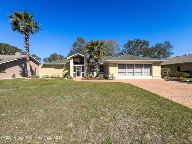 view of front facade with a garage, a front lawn, decorative driveway, and stucco siding