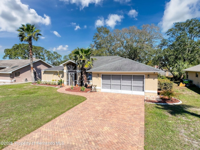 view of front of property with a garage, roof with shingles, decorative driveway, a front lawn, and stucco siding