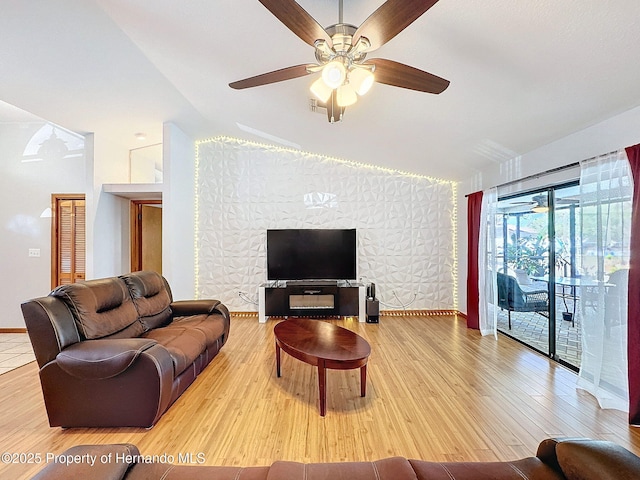 living area featuring ceiling fan, baseboards, and wood finished floors