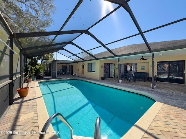 pool with a ceiling fan, a lanai, and a patio area