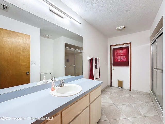 bathroom featuring toilet, a shower stall, visible vents, and tile patterned flooring