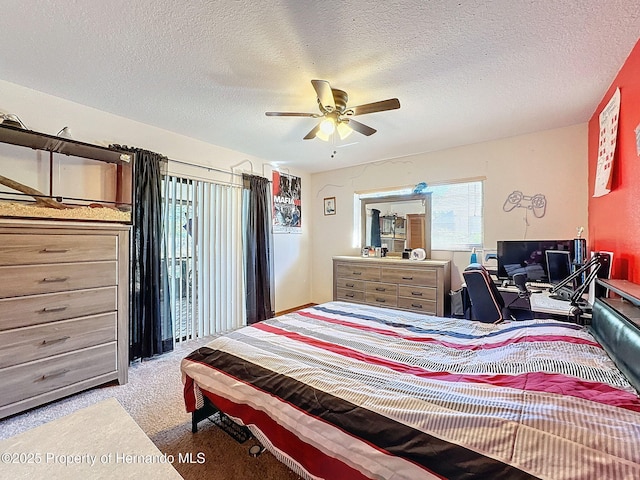 carpeted bedroom with a ceiling fan and a textured ceiling