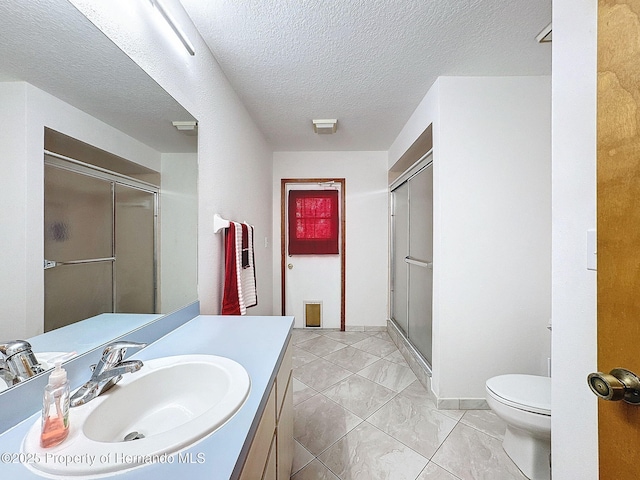 full bathroom with toilet, a stall shower, a textured ceiling, and vanity