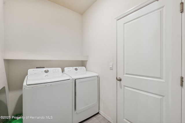 clothes washing area with washer and dryer, laundry area, and light tile patterned floors