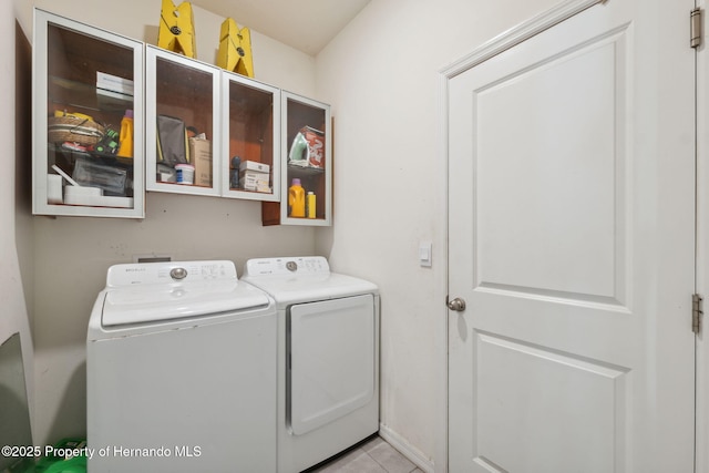 washroom featuring laundry area, light tile patterned flooring, and washing machine and dryer