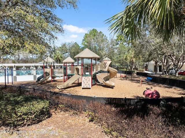 community play area with fence and a community pool