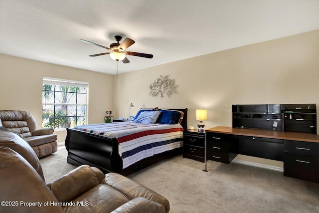 bedroom with light colored carpet and a ceiling fan