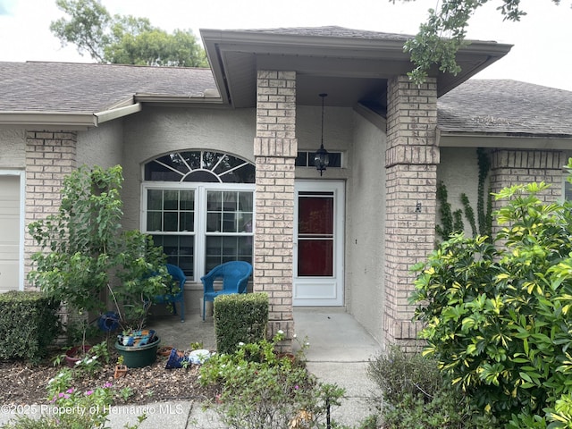 7441 Baywood Forest Cir, Spring Hill, FL 34606 - entrance to property with roof with shingles and stucco siding