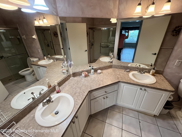 7441 Baywood Forest Cir, Spring Hill, FL 34606 - full bathroom with a shower stall, double vanity, toilet, and tile patterned floors