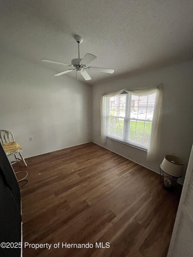 7441 Baywood Forest Cir, Spring Hill, FL 34606 - spare room with wood finished floors, a textured ceiling, and a ceiling fan