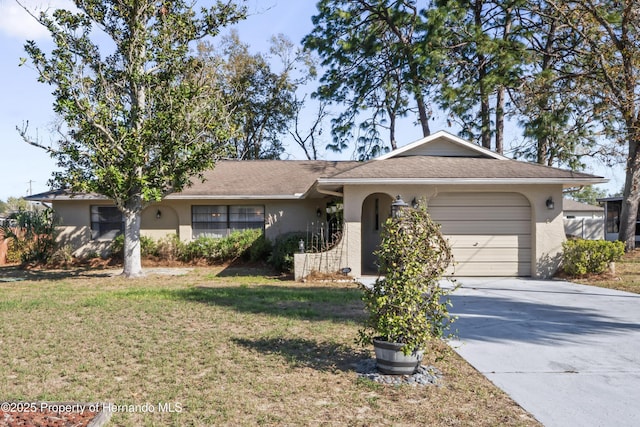 single story home with a front yard, driveway, an attached garage, and stucco siding