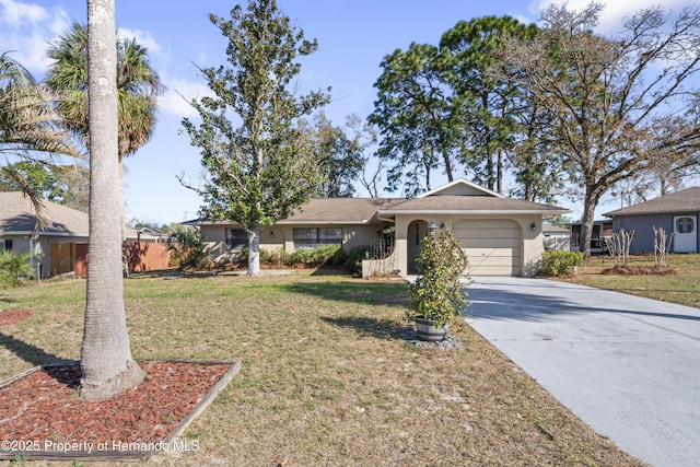 ranch-style house with an attached garage, fence, driveway, stucco siding, and a front lawn