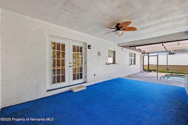 pool with a ceiling fan, french doors, a patio area, and a lanai