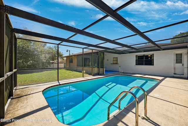 pool featuring a patio, a yard, and glass enclosure