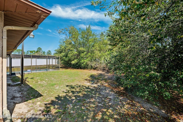 view of yard featuring a fenced in pool and fence