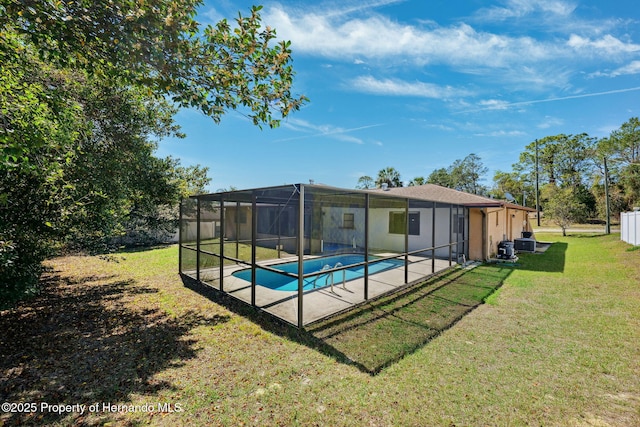 outdoor pool featuring a patio area, glass enclosure, and a lawn