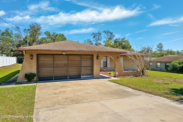 single story home with a garage, concrete driveway, a front lawn, and stucco siding