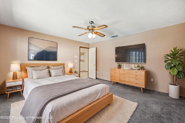 carpeted bedroom featuring a ceiling fan and visible vents