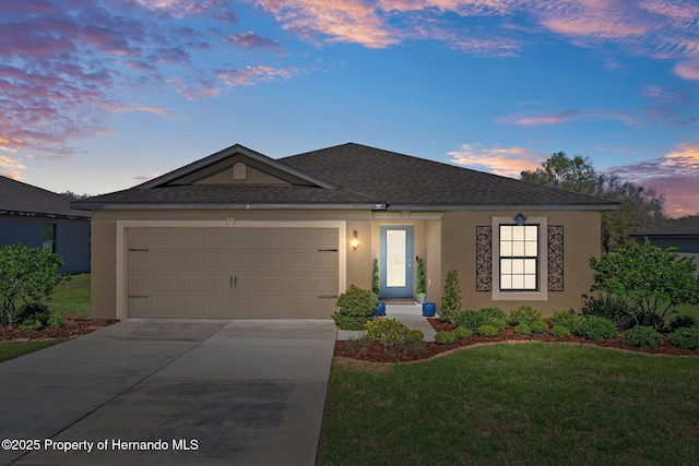 single story home with driveway, a garage, a shingled roof, a front lawn, and stucco siding