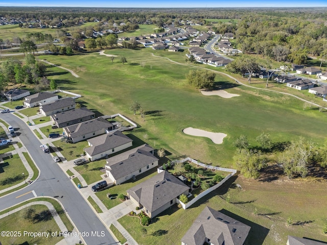 birds eye view of property featuring view of golf course and a residential view