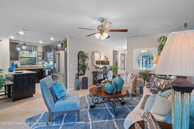 living room featuring a ceiling fan, recessed lighting, visible vents, and light tile patterned floors