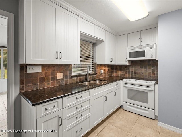 kitchen with white appliances, a sink, backsplash, and light tile patterned floors