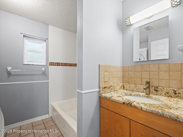 bathroom with visible vents, tile patterned flooring, a textured ceiling, vanity, and backsplash