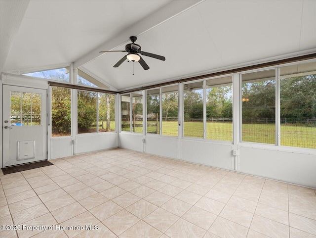 unfurnished sunroom with a ceiling fan and lofted ceiling with beams