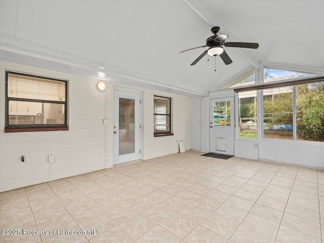 unfurnished sunroom with vaulted ceiling with beams and a ceiling fan