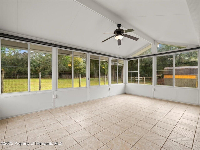 unfurnished sunroom featuring vaulted ceiling with beams and ceiling fan