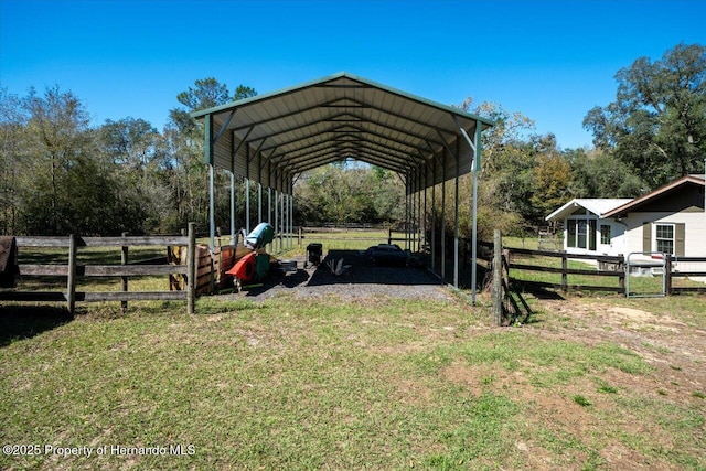 view of vehicle parking featuring a carport, fence, and driveway