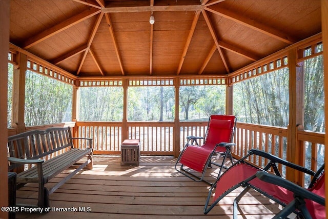 wooden terrace with a wooded view and a gazebo