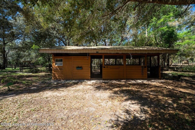 view of outdoor structure featuring a carport, an exterior structure, and an outdoor structure