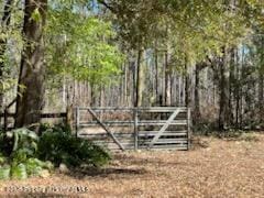 view of gate featuring fence