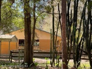 view of property exterior featuring fence and an outbuilding