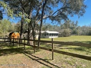 view of yard featuring a rural view and fence