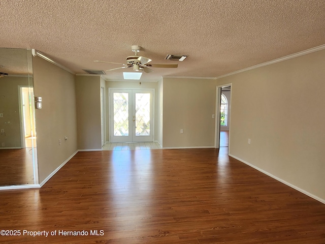7106 Green Abbey Way, Spring Hill, FL 34606 - empty room featuring ornamental molding, wood finished floors, ceiling fan, french doors, and a textured ceiling
