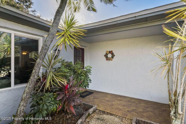 property entrance with stucco siding