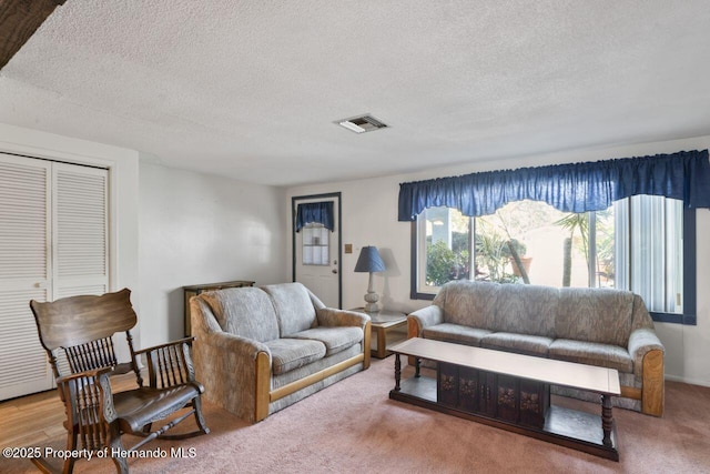 living room featuring visible vents and a textured ceiling