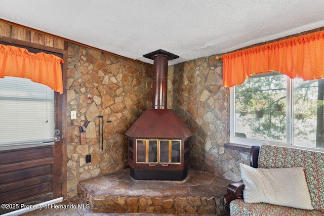 details featuring a textured ceiling and a wood stove