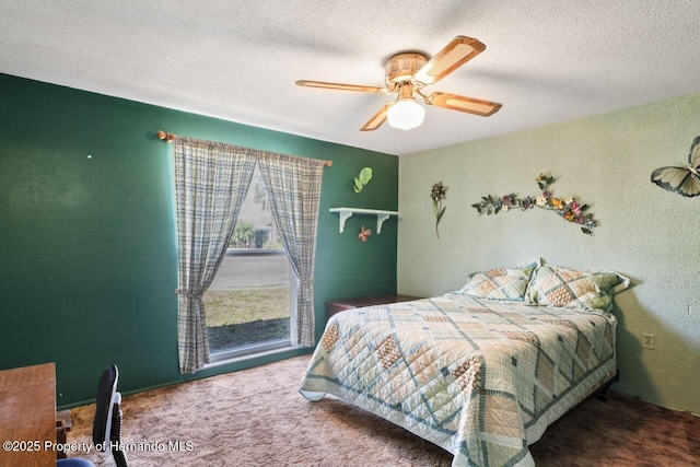 bedroom with a textured ceiling, ceiling fan, and carpet