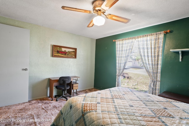 bedroom with carpet, a textured wall, a textured ceiling, and ceiling fan