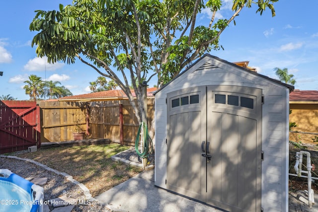 view of shed featuring fence