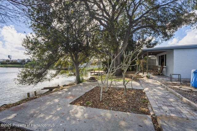 view of yard featuring a patio area and a water view