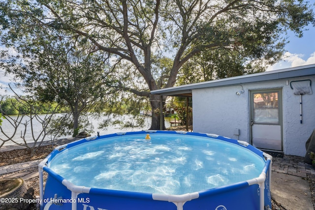 view of swimming pool with a hot tub