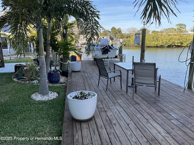 dock area with a yard, a water view, and boat lift