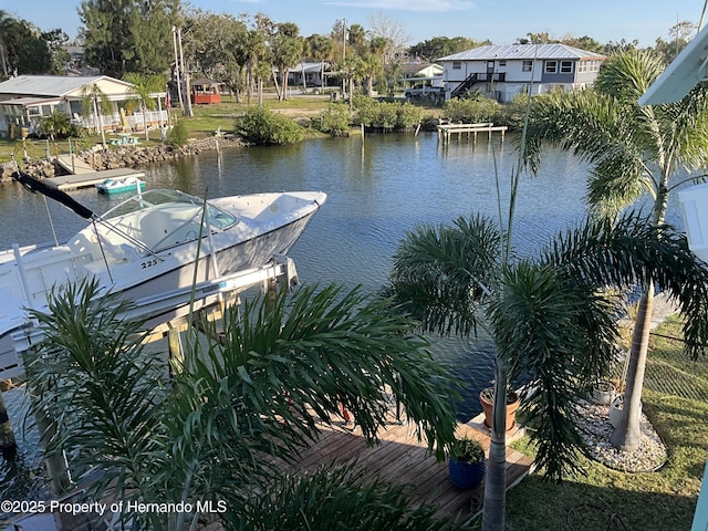 dock area featuring a water view and fence